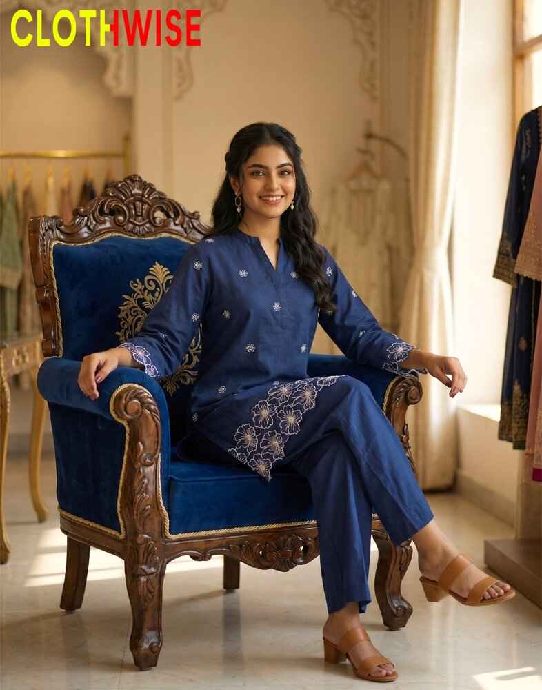 Woman in a blue traditional outfit sitting on an ornate chair with 'CLOTHWISE' branding.