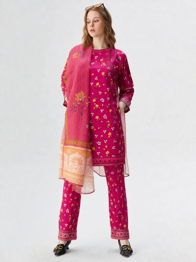 Woman wearing a pink embroidered traditional outfit on a white background