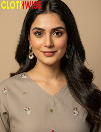 Woman wearing a beige embroidered top with 'CLOTHWISE' branding.