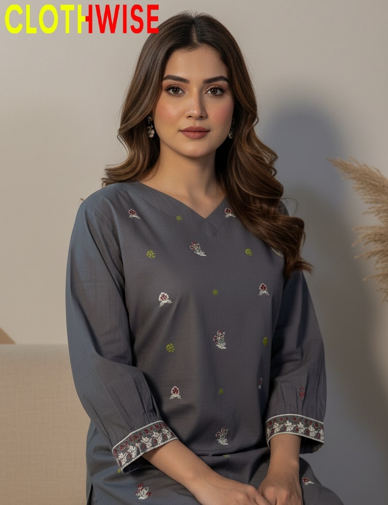 Woman wearing a gray kurta with intricate patterns, sitting against a neutral background with 'CLOTHWISE' branding.