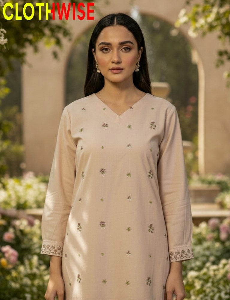 Woman wearing a light pink kurta with floral patterns in an outdoor setting, with 'CLOTHWISE' branding.