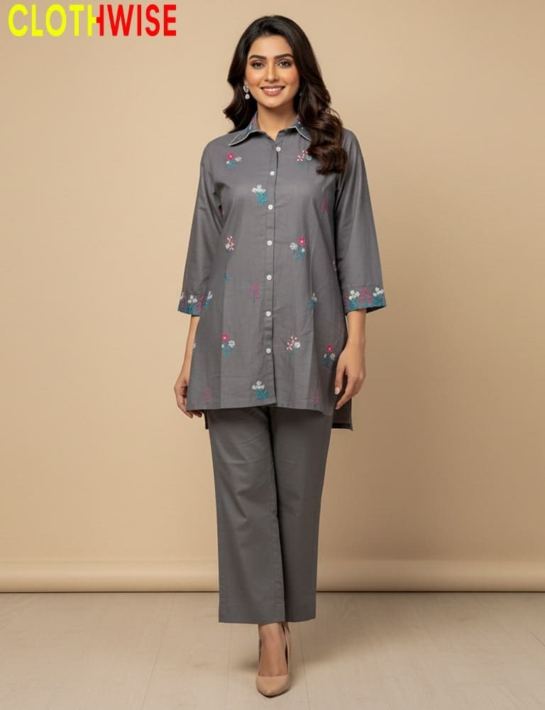 Woman wearing a gray embroidered shirt and pants with 'ClothWise' branding on a beige background