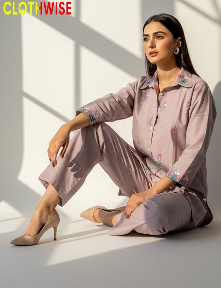 Woman in a matching outfit sitting on the floor with 'CLOTHWISE' branding.