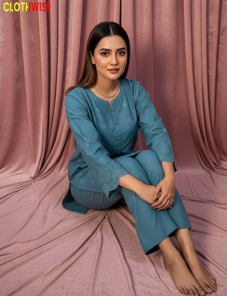 Woman in a blue outfit sitting on a pink fabric background with 'Clothwise' branding.