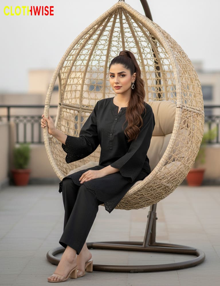 Woman sitting in a woven egg chair on a patio