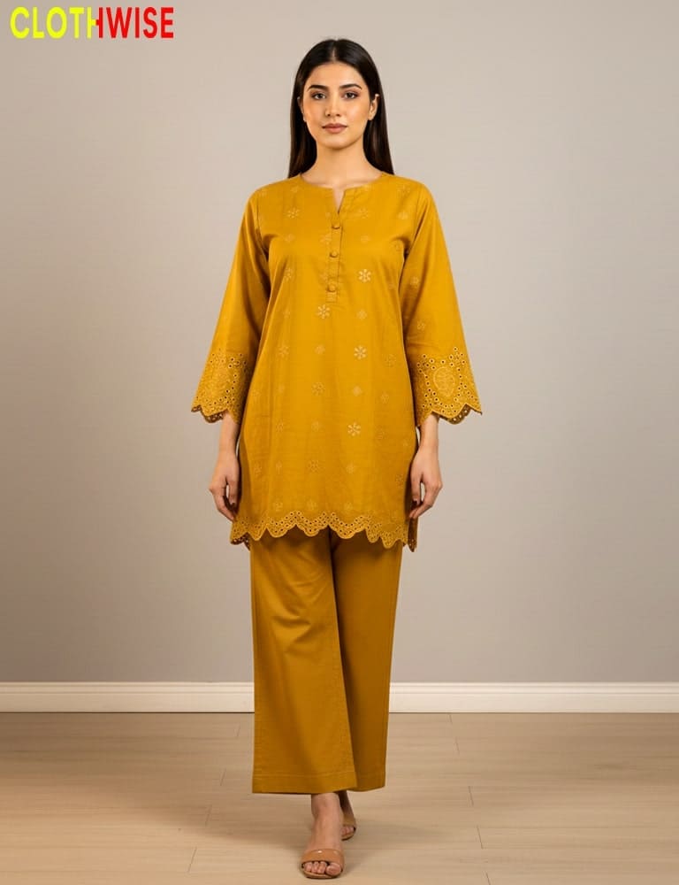 Woman wearing a mustard yellow outfit with lace details on a plain background, branded 'Clothwise'.