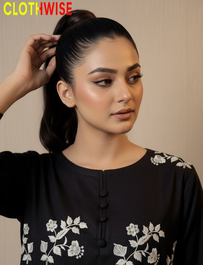 Woman wearing a black top with white floral embroidery, with 'CLOTHWISE' branding.