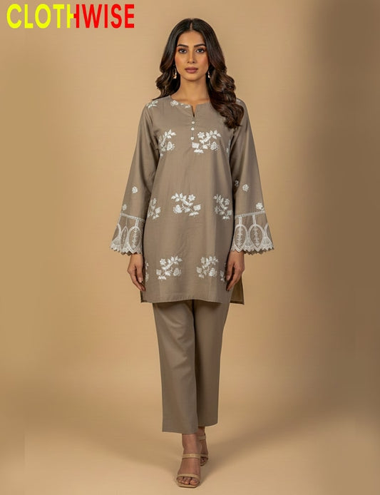 Woman wearing a brown kurta with white floral embroidery on a beige background, branded 'ClothWise'.