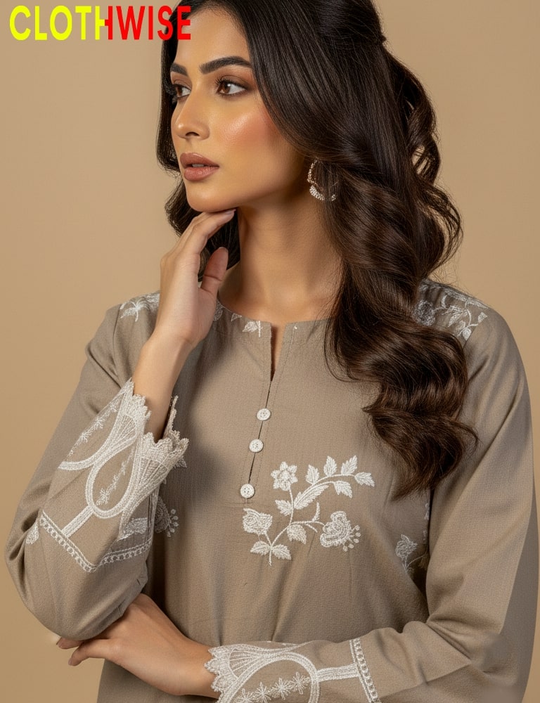 Woman wearing a brown embroidered top with lace details on a beige background, featuring the brand 'Clothwise'.