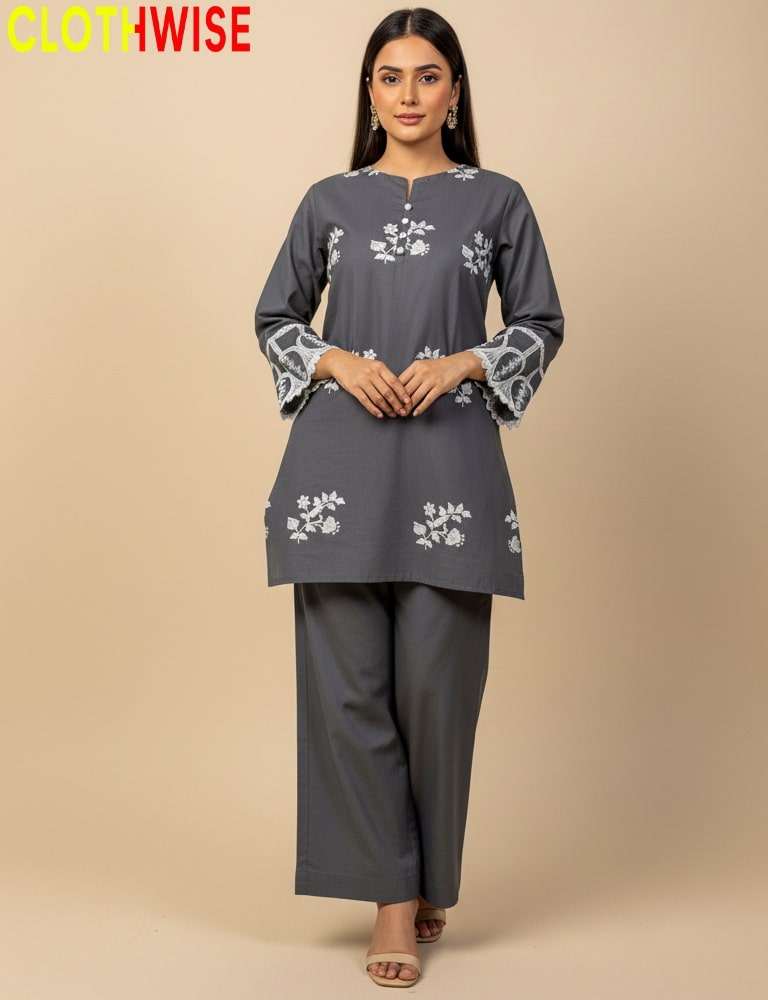 Woman wearing a gray outfit with floral embroidery on a beige background, branded 'CLOTHWISE'.