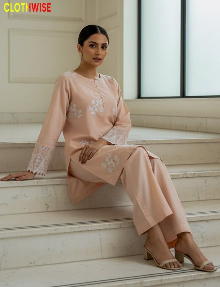 Woman in a peach outfit sitting on steps with 'Clothwise' branding.