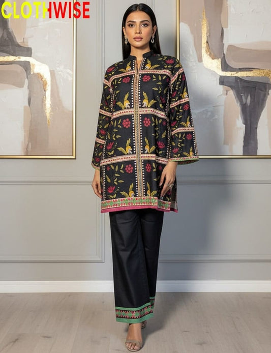 Woman wearing a patterned black outfit with 'CLOTHWISE' branding.