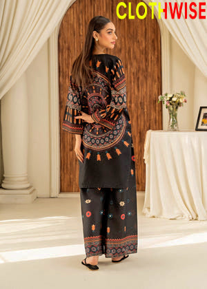 Woman in a black and patterned outfit standing in a decorated room with 'Clothwise' branding.