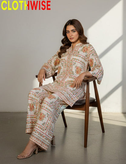 Woman sitting on a chair wearing a patterned outfit with 'CLOTHWISE' branding.