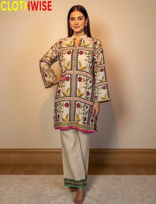 Woman wearing a patterned kurta with white pants, standing against a plain background with 'CLOTHWISE' branding.
