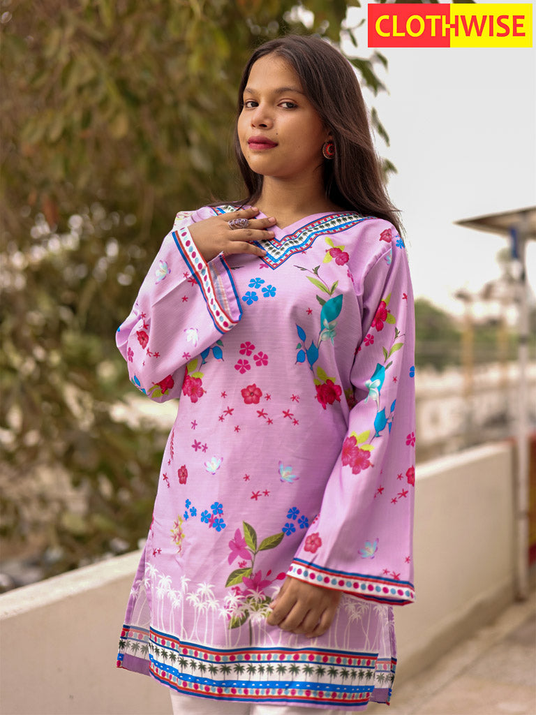 Girl wearing a pink floral dress with a blurred outdoor background