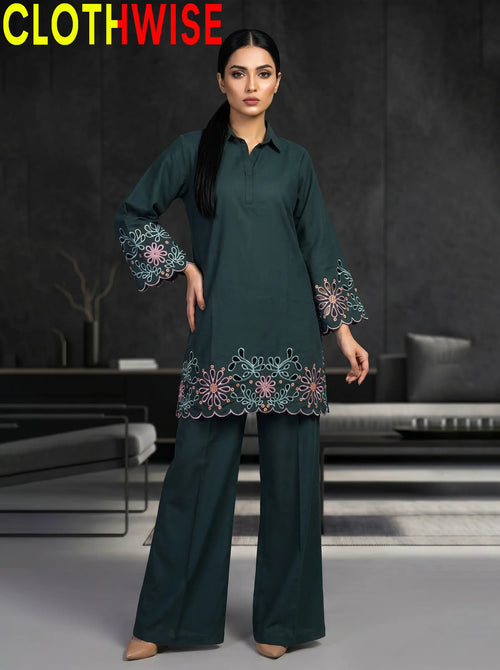 Woman wearing a dark green outfit with floral embroidery in a modern setting, branded 'ClothWise'.