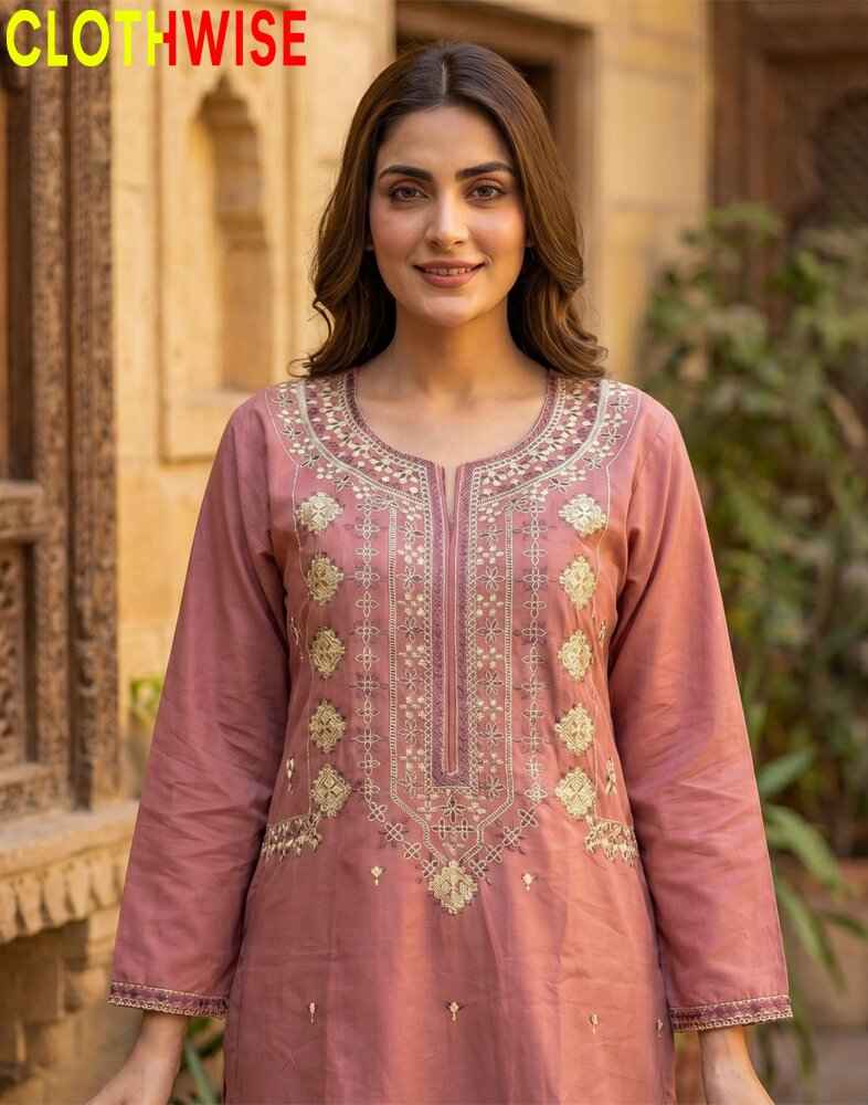Woman wearing a pink embroidered traditional outfit with 'CLOTHWISE' branding.
