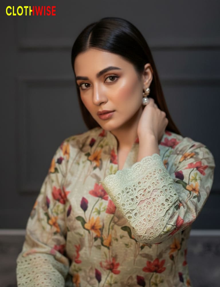 Woman wearing a floral blouse with lace details, posing against a dark background.