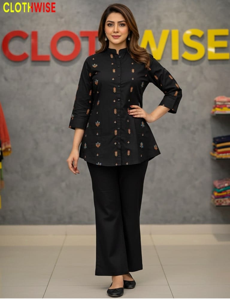 Woman in a black outfit standing in front of a 'CLOTHWISE' branded wall.
