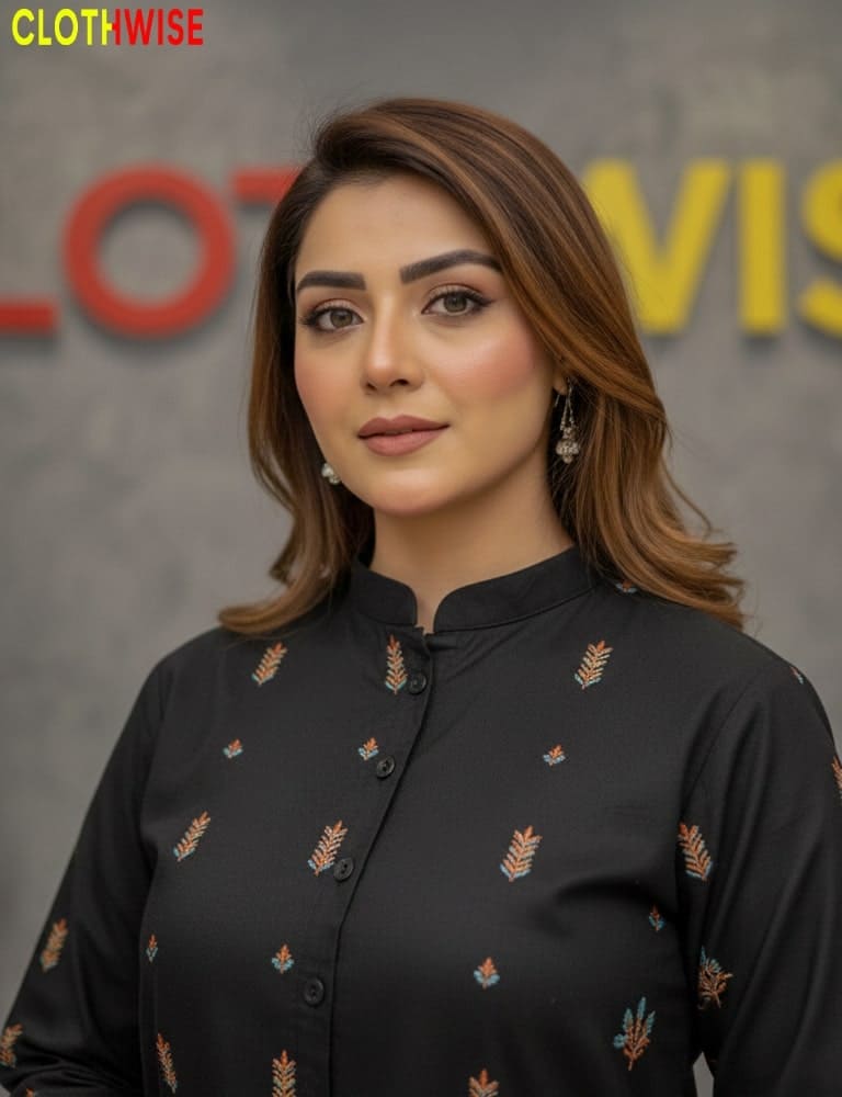 Woman wearing a black embroidered shirt with a blurred background featuring 'CLOTHWISE' branding.