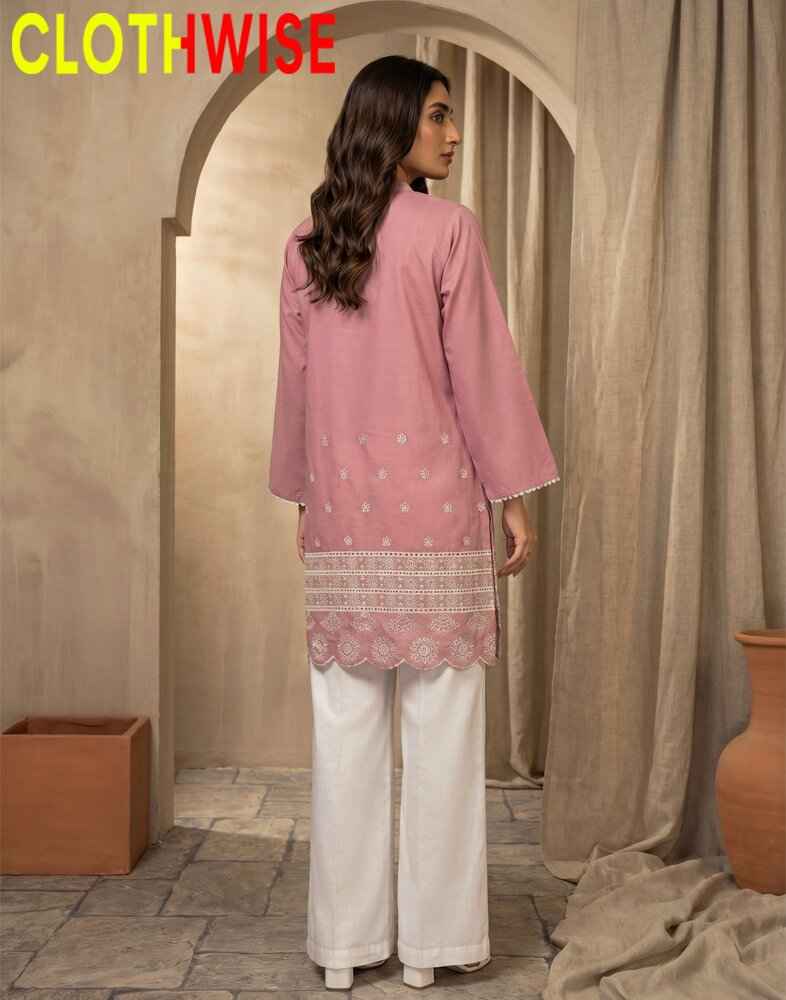 Woman wearing a pink top and white pants in an indoor setting with 'CLOTHWISE' branding.