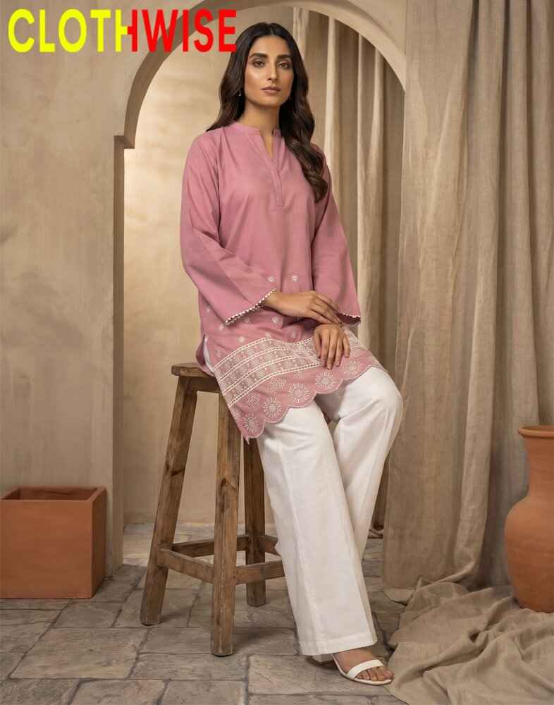 Woman wearing a pink kurta with white pants sitting on a wooden stool, with 'CLOTHWISE' branding.