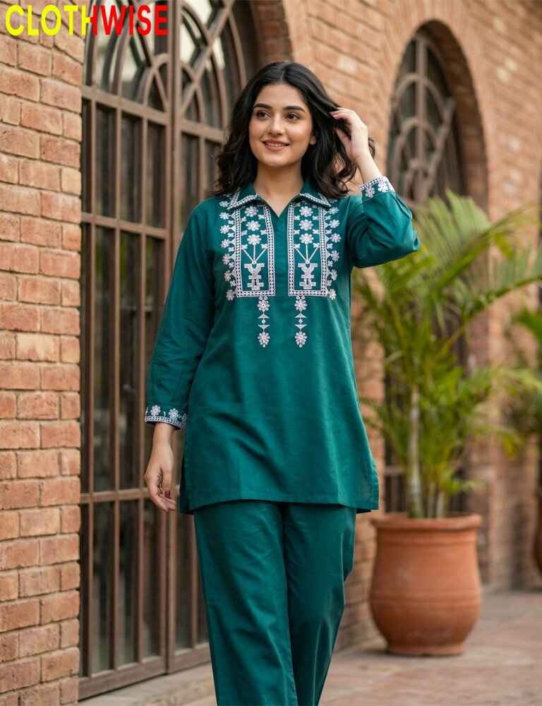 Woman wearing a green embroidered dress with 'CLOTHWISE' branding.