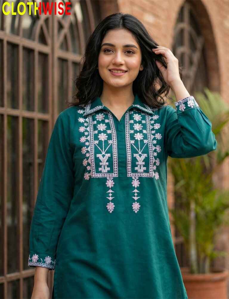 Woman wearing a green embroidered dress with 'CLOTHWISE' branding.
