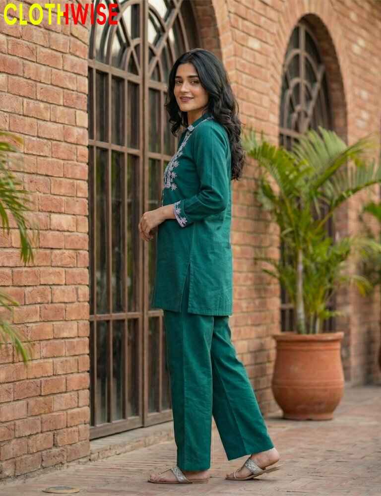 Woman wearing a green embroidered dress with 'CLOTHWISE' branding.