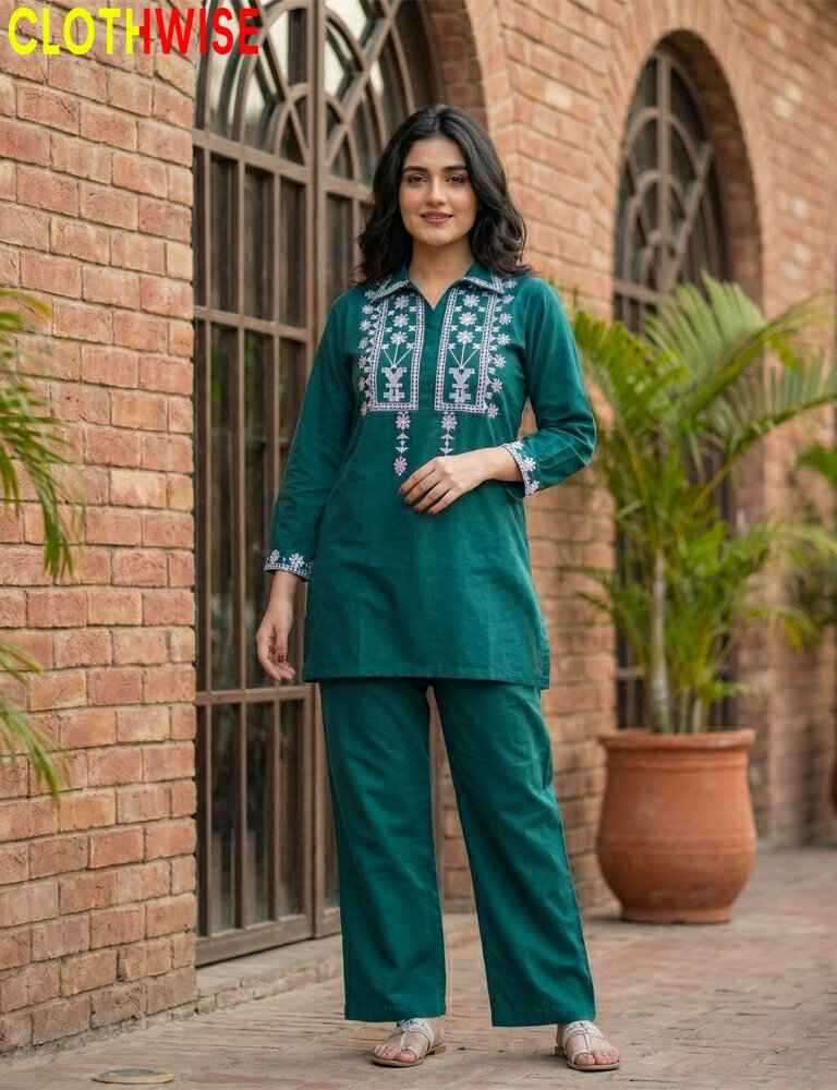 Woman wearing a green embroidered dress with 'CLOTHWISE' branding.
