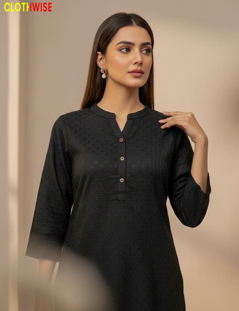 Woman wearing a black kurta with a neutral background