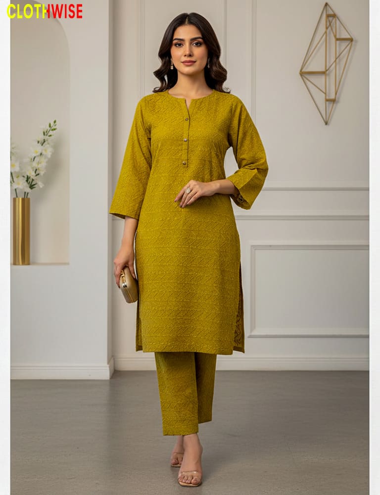 Woman wearing a mustard yellow kurta with pants in an indoor setting.