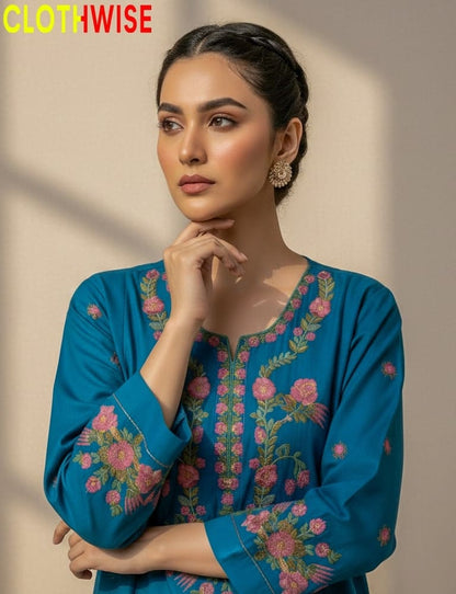 Woman wearing a blue embroidered outfit with 'CLOTHWISE' branding.