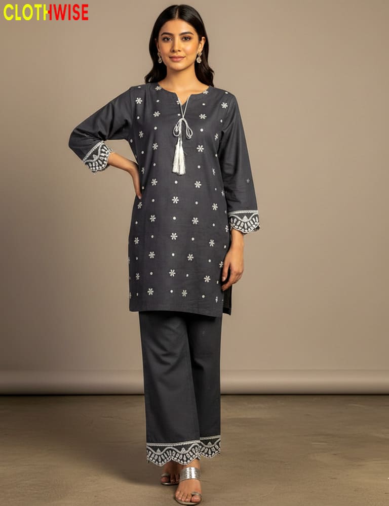 Woman wearing a dark gray traditional outfit with white patterns on a beige background, branded 'Clothwise'.