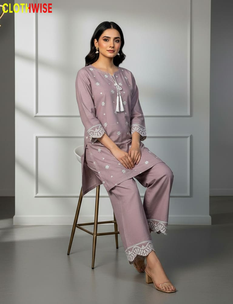 Woman in a pink outfit sitting on a stool against a white paneled wall with 'Clothwise' branding.