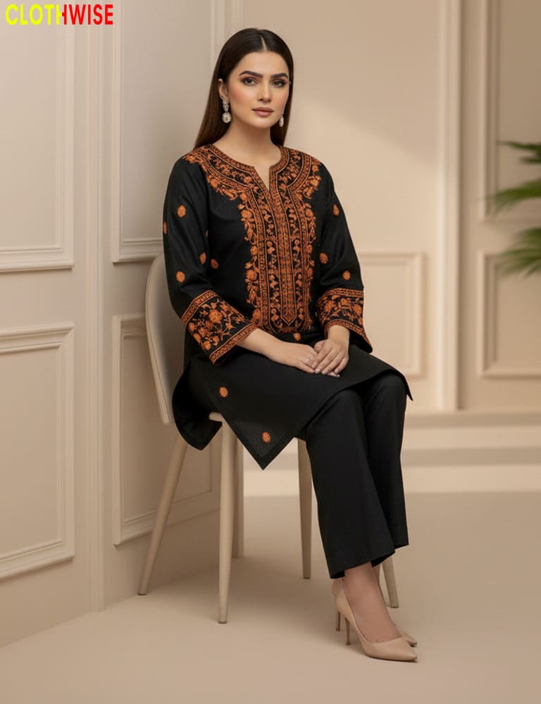 Woman sitting on a chair wearing a black and orange embroidered outfit with 'Clothinwise' branding.