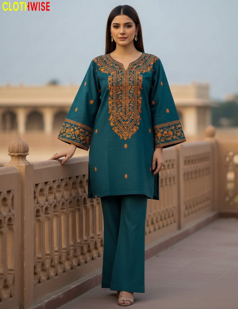 Woman in teal embroidered outfit standing on a bridge with 'Clothinwise' branding.
