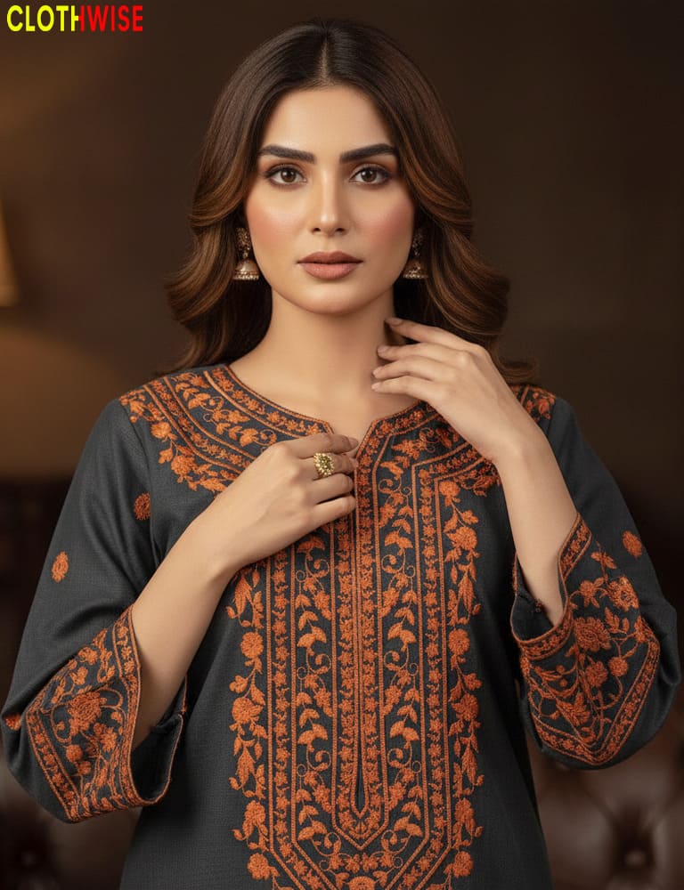 Woman wearing a dark gray and orange embroidered traditional outfit with 'CLOTHWISE' branding.