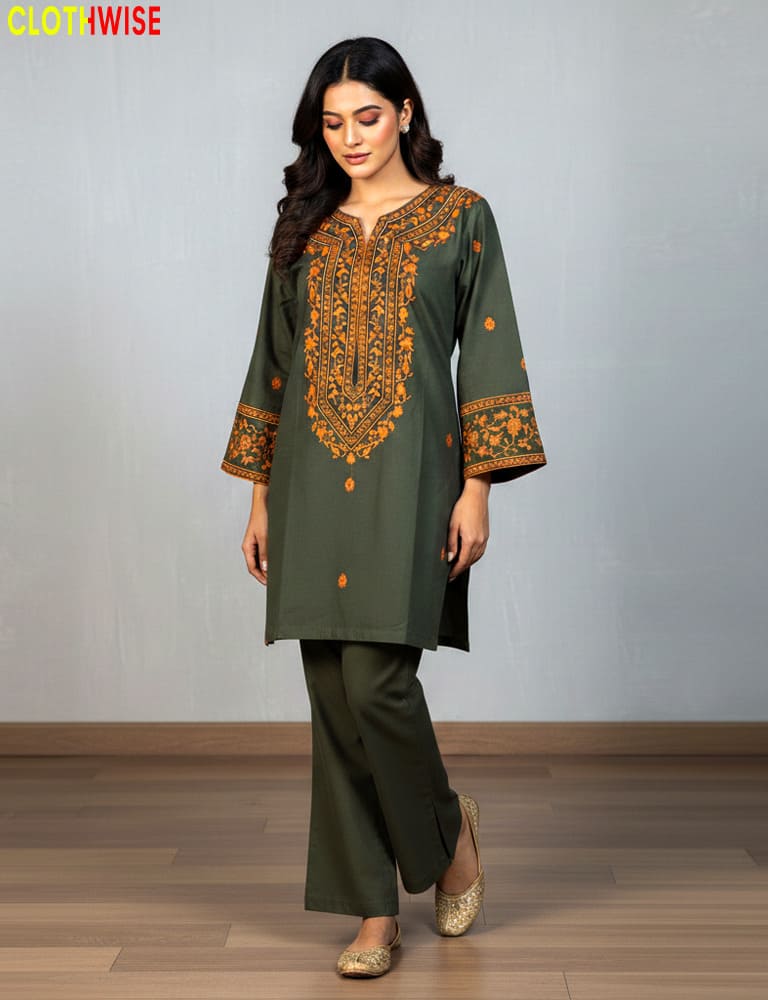 Woman wearing a olive embroidered outfit with a plain background