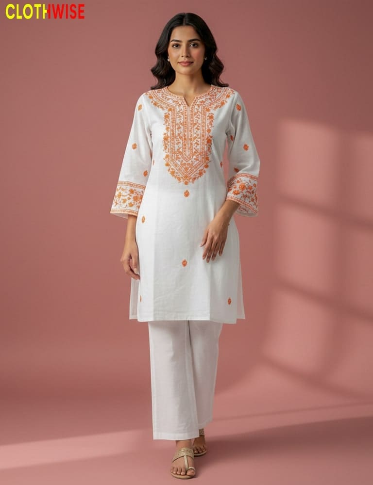 Woman wearing a white embroidered outfit with orange details on a pink background, branded 'Clothwise'.