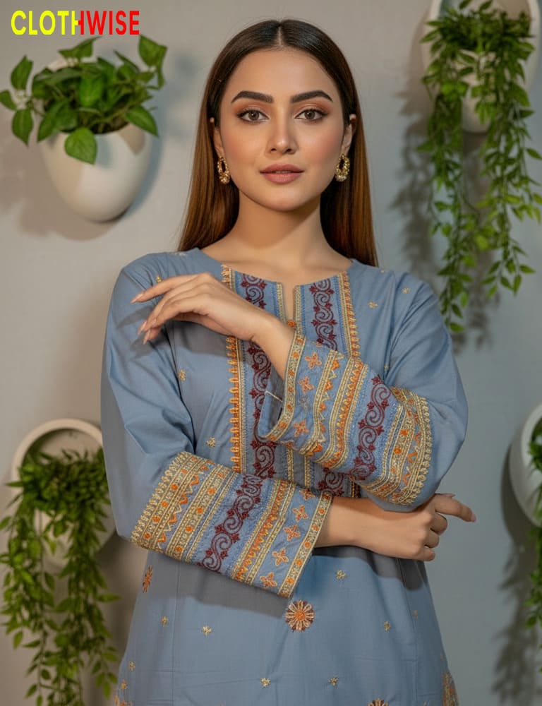 Woman wearing a blue embroidered dress with green plants in the background, branded 'Clothwise'.