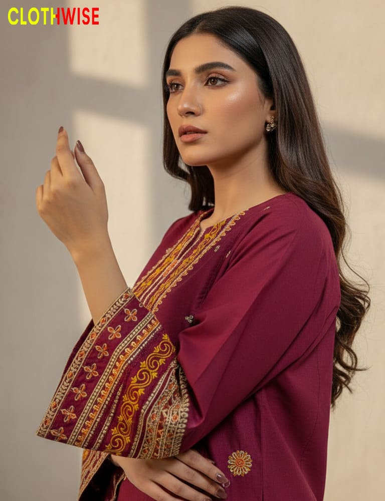 Woman wearing a maroon traditional outfit with intricate patterns, branded 'Clothwise'.