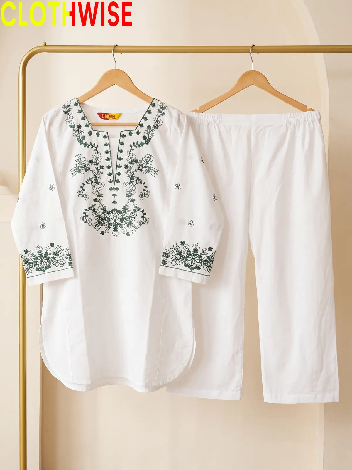 Azadi Green Thread Embroidered 2-piece cotton lawn suit displayed on hanger
