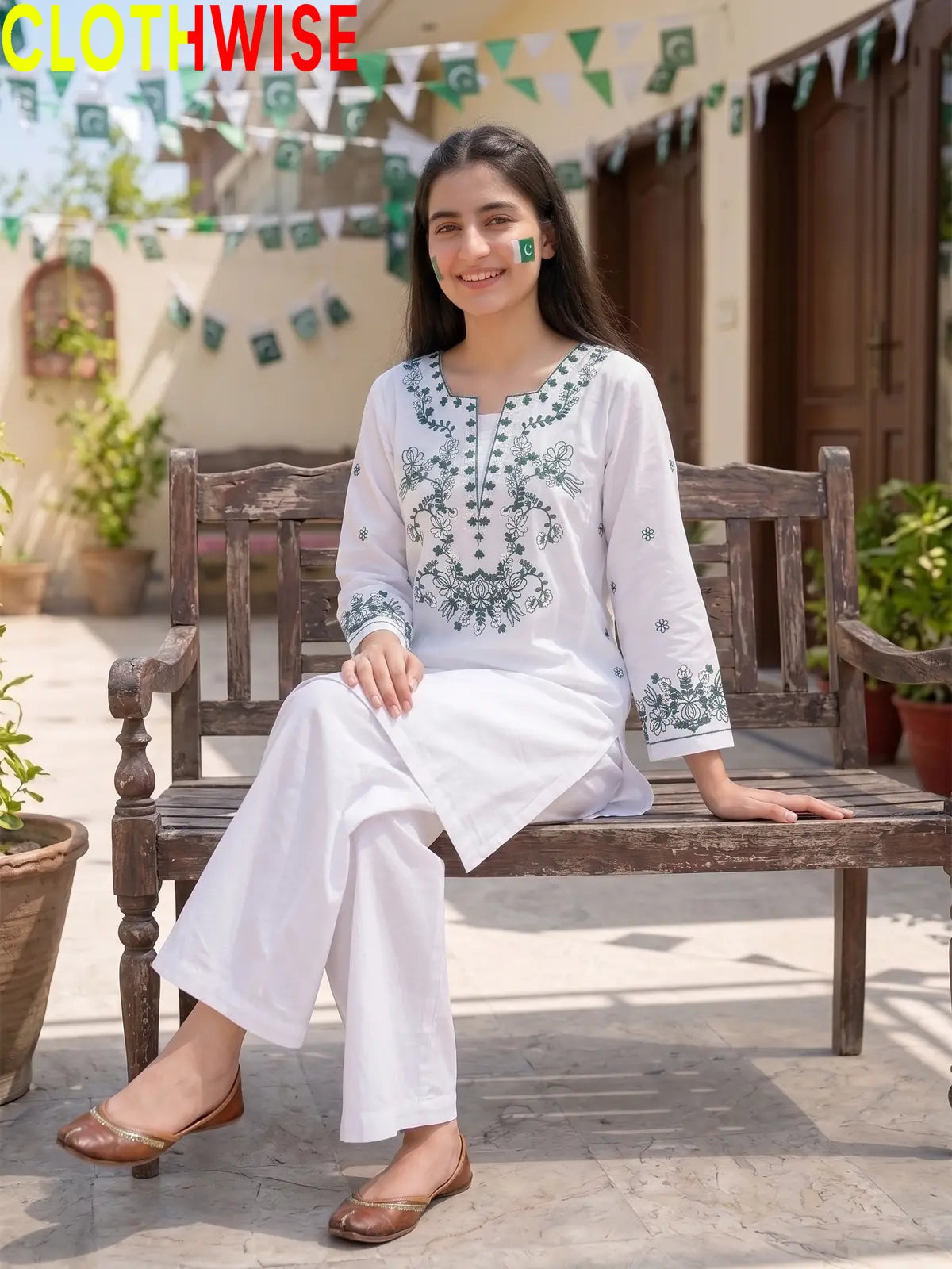 Model sitting in Azadi Green Thread Embroidered 2-piece lawn suit