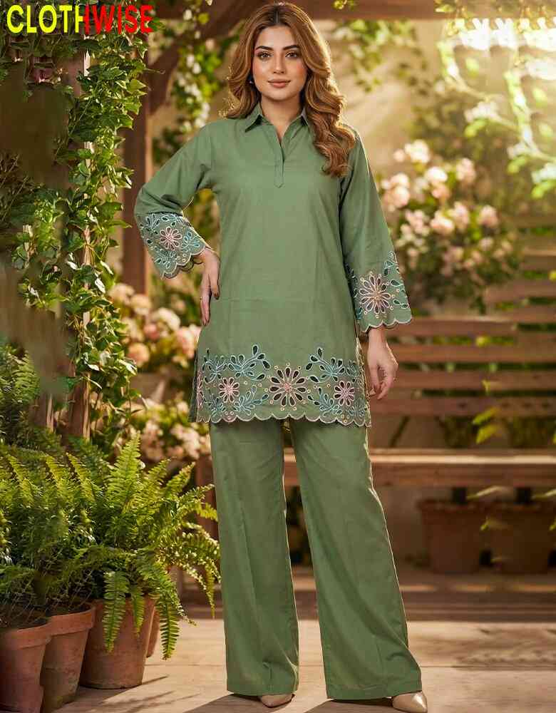 Woman wearing a green outfit with floral embroidery in an outdoor setting.
