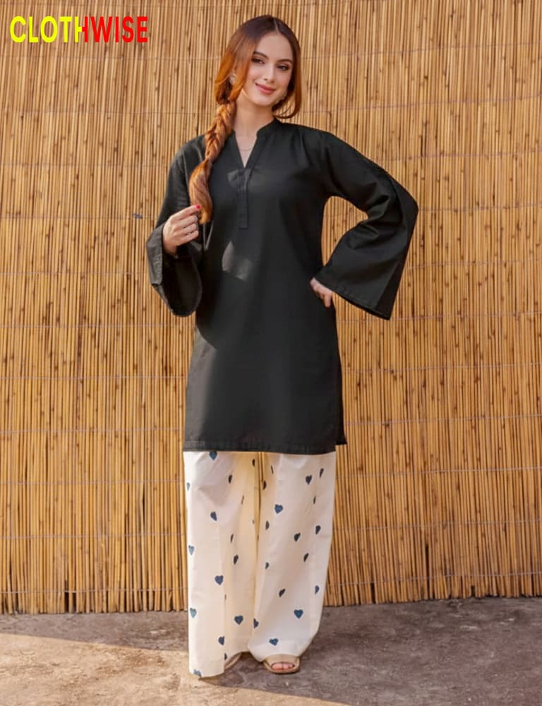 Woman wearing a black top and white pants with heart patterns against a bamboo wall, branded 'Clothwise'.