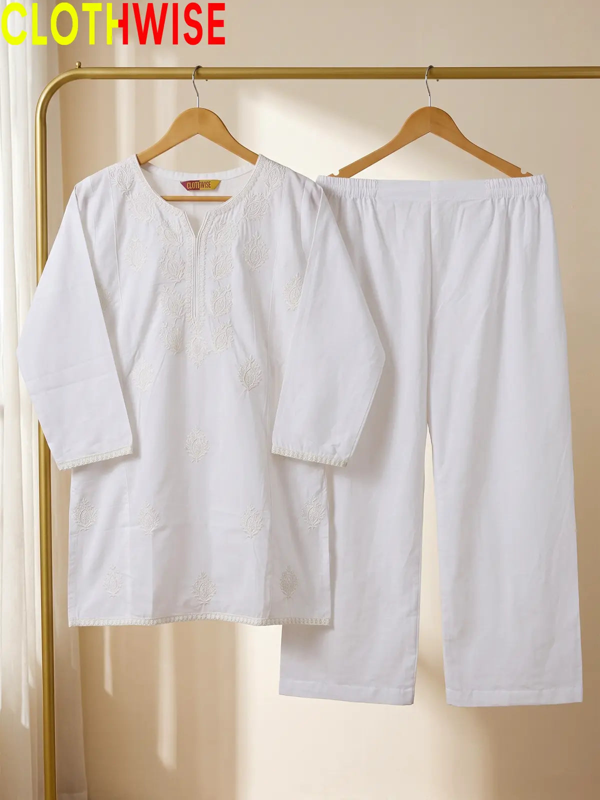 Azadi Indian Whitework Embroidered 2-piece cotton lawn suit displayed on hanger