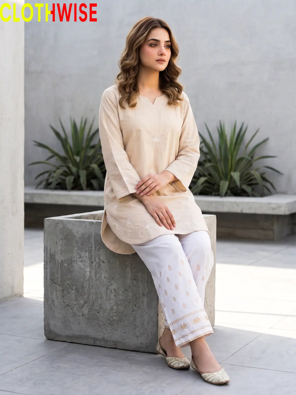 Petal ivory embroidered suit - sitting view showing flared bottom
