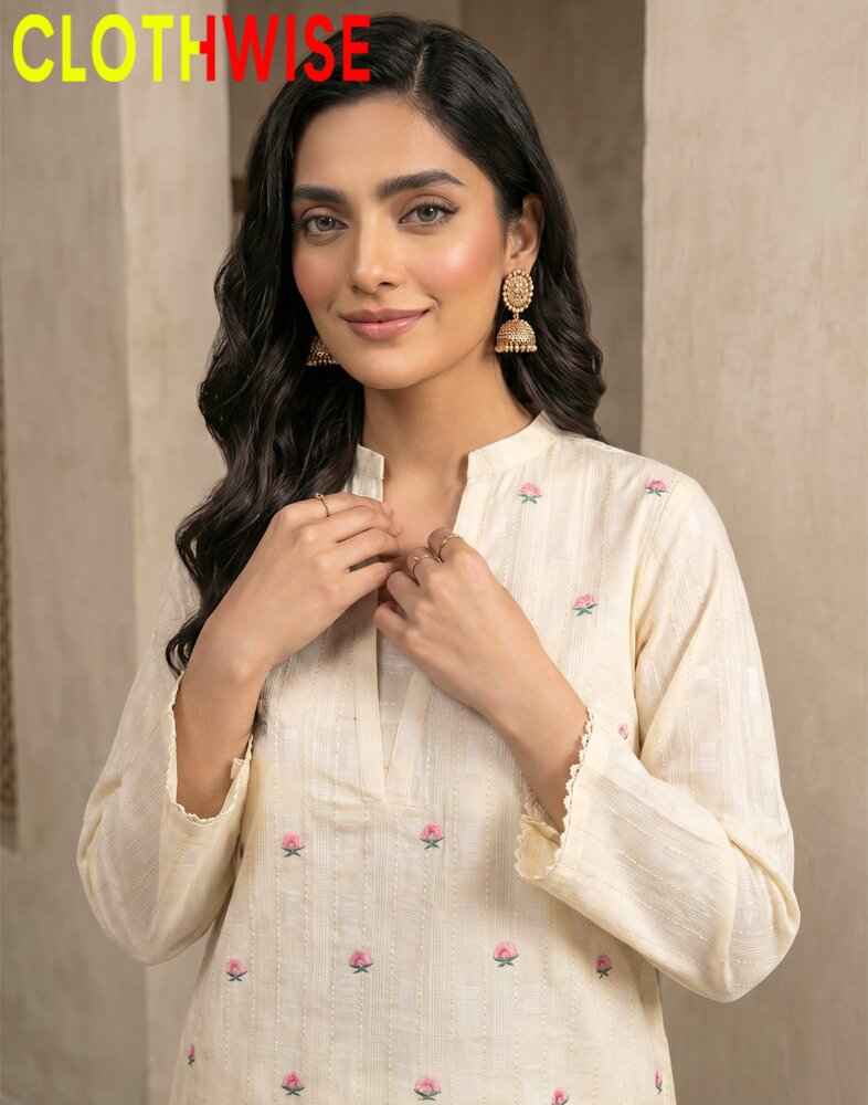 Woman wearing a white embroidered outfit with 'CLOTHWISE' branding.